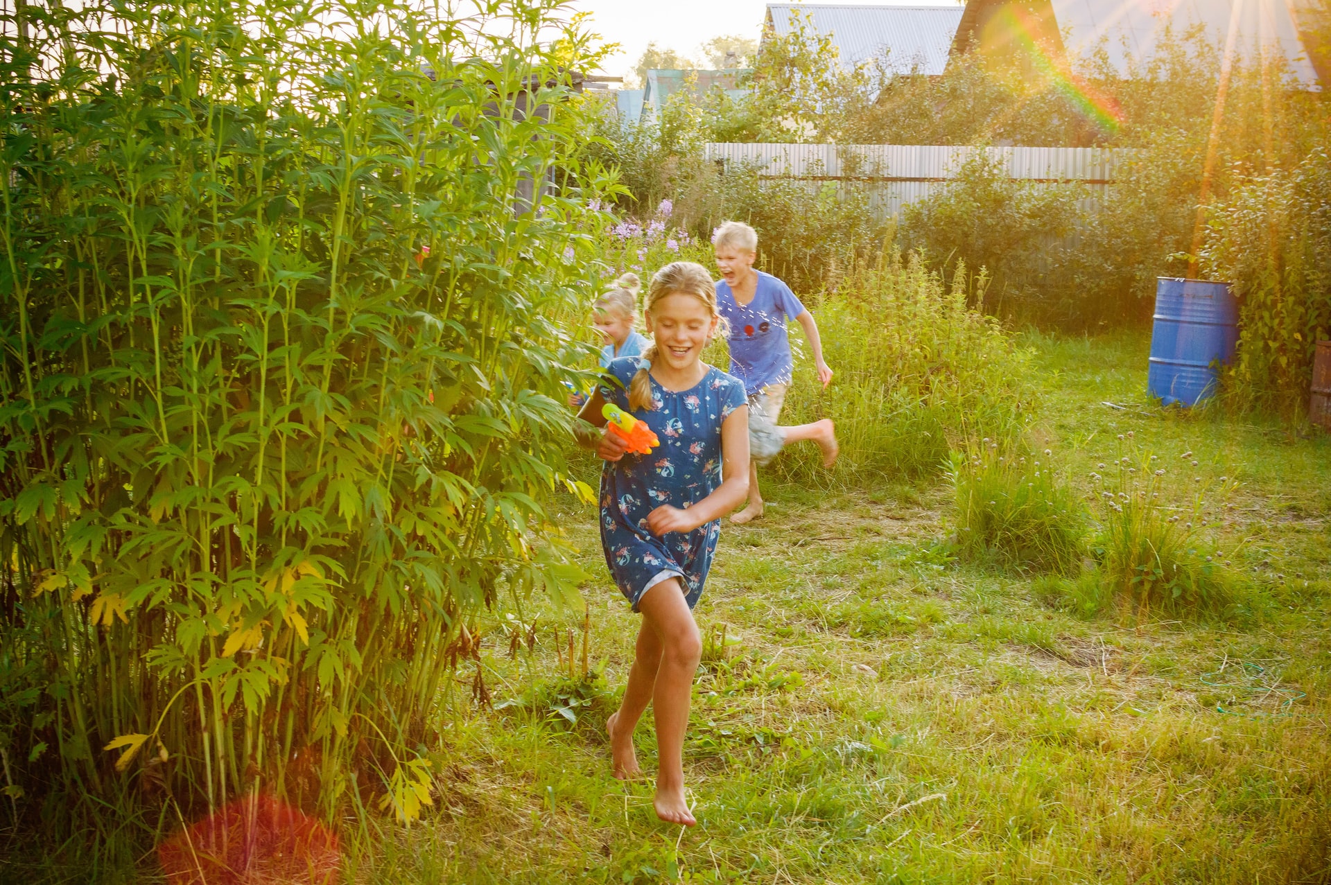 kids running around backyard in springtime